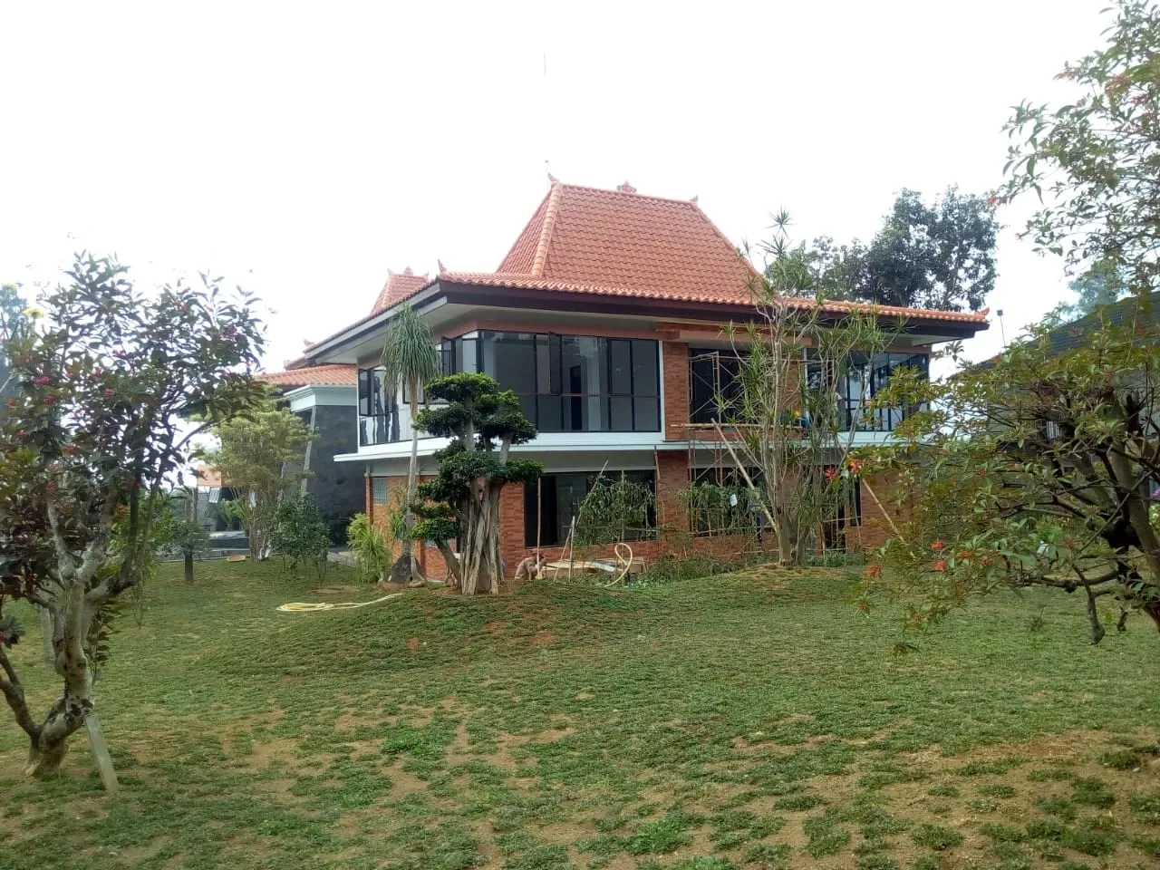 Fasad villa di Cisarua, Bogor, dengan pekerjaan lansekap.